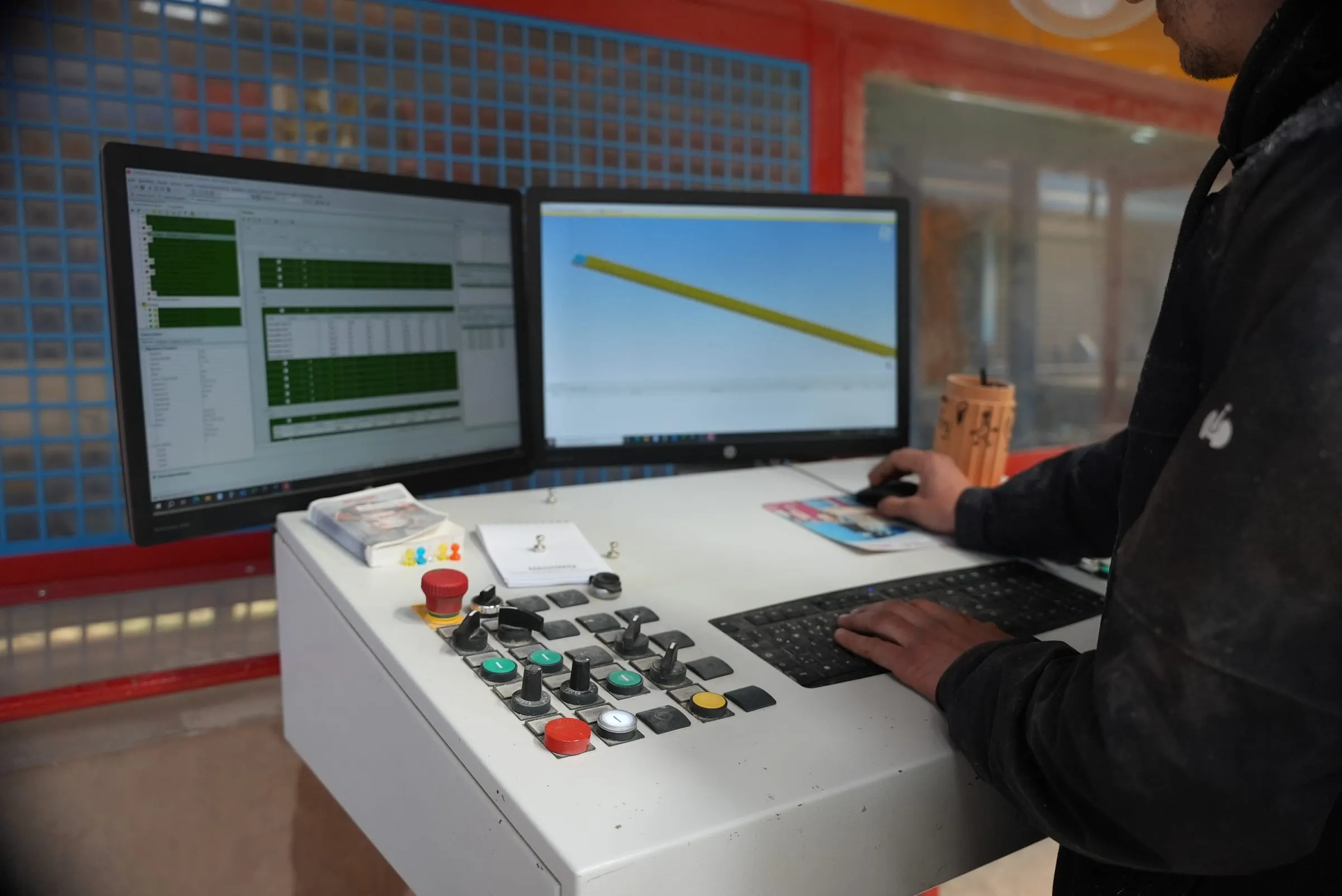 Steuerpult der CNC-Abbundanlage mit Monitoren zur Übernahme der Bauteilgeometrie