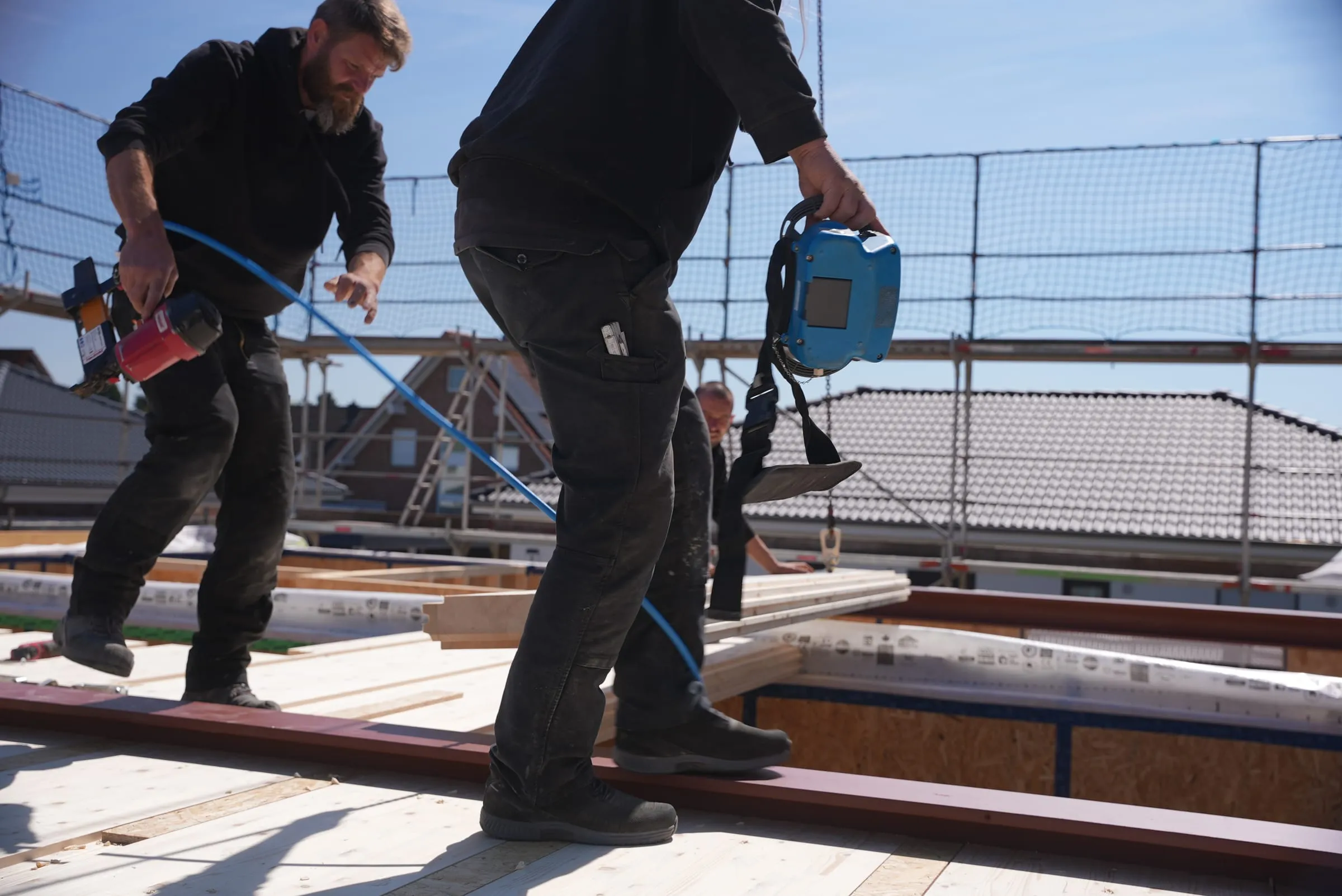 Mitarbeiter steuert den Kran per Funkfernsteuerung während der Montage der Elementdecke